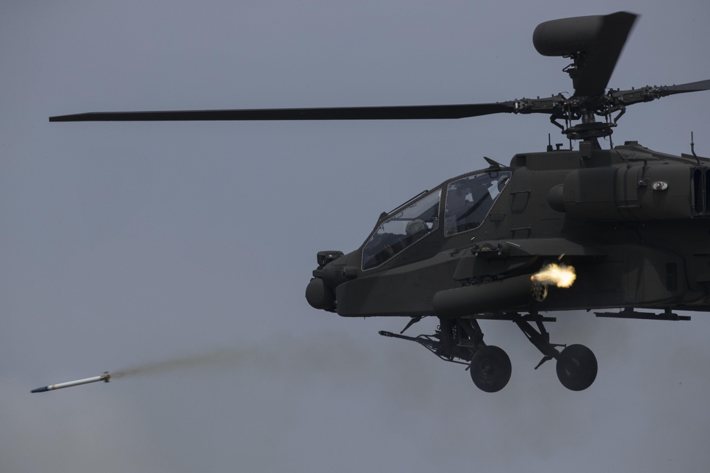 An AH-64E Apache Guardian attack helicopter of the South Korean Army fires a rocket during a joint drill with the U.S. military at a training field in Pocheon, Gyeonggi Province, on April 26, 2017. (Yonhap) 
