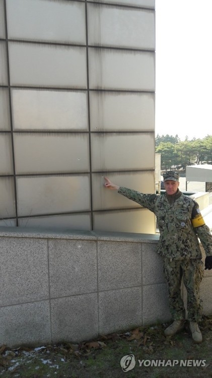 A U.S. military officer shows a bullet trace on the wall of a JSA building resulting from North Korean troops' firing at a fellow soldier defecting to South Korea via Panmunjom in this photo taken Nov. 27, 2017. (Joint Press Corps-Yonhap)