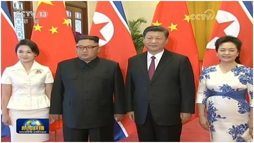 Footage from China's state-run CCTV shows North Korean leader Kim Jong-un (2nd from L) and his wife Ri Sol-ju posing for a photo with Chinese President Xi Jinping and his wife Peng Liyuan at the Great Hall of the People on June 19, 2018. (Yonhap)