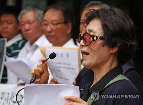 The bereaved family members of the victims of the KAL 858 bombing hold a news conference on their filing of a lawsuit against its culprit Kim Hyun-hui in front of the Seoul Central District Court on July 23, 2018. (Yonhap) 