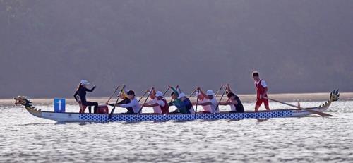 In this file photo from July 31, 2018, members of the unified Korean dragon boat racing team train at Chungju Tangeum Lake International Rowing Center in Chungju, 150 kilometers south of Seoul. (Yonhap)