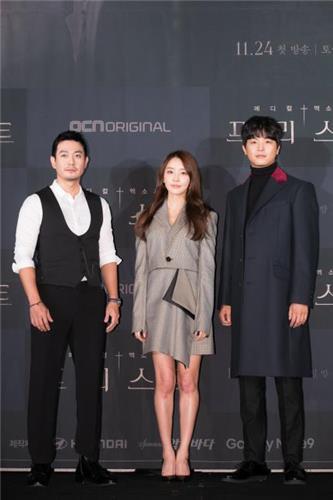 This photo provided by OCN shows three cast members of "Priest" posing for photos during a media event in Seoul on Nov. 12, 2018. (Yonhap)