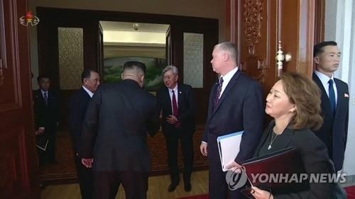 This photo captured from North Korea's Korean Central TV shows Andrew Kim (C), head of the U.S. Central Intelligence Agency's Korea Mission Center, shaking hands with North Korean leader Kim Jong-un in Pyongyang on Oct. 7, 2018. (For Use Only in the Republic of Korea. No Redistribution.) (Yonhap)