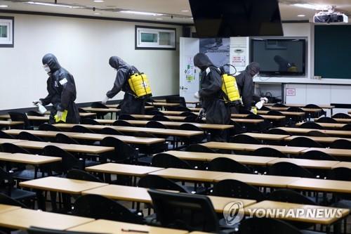 Quarantine officials carry out a disinfection operation against the new coronavirus at a cram school in Daegu, 302 kilometers south of Seoul, on March 15, 2020. (Yonhap)