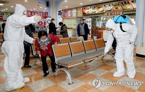 Health officials disinfect a public bus terminal in Taean, 144 kilometers southwest of Seoul, to prevent COVID-19 from spreading on March 18, 2021, in this photo provided by the county government. (PHOTO NOT FOR SALE) (Yonhap)