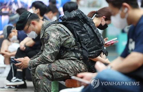 This file photo, taken June 20, 2022, shows a soldier using a mobile phone at a station in Seoul. (Yonhap)