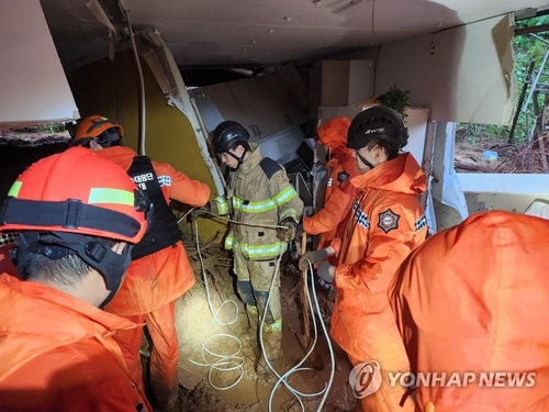 Firefighters launch a rescue operation in a home hit by a landslide in Cheongyang, South Chungcheong Province, on July 15, 2023, in this photo provided by the Chungnam Fire Station. (PHOTO NOT FOR SALE) (Yonhap)