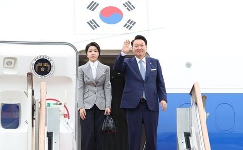 President Yoon Suk Yeol (R) waves ahead of his departure for the Czech Republic from Seoul Air Base in Seongnam, just south of Seoul, on Sept. 19, 2024, as first lady Kim Keon Hee stands next to him. (Yonhap)