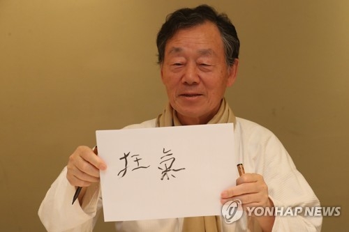 한승원 작가가 13일 서울 중구 정동 달개비에서 열린 산문집 '꽃을 꺾어 집으로 돌아오다' 출간 간담회에서 '광기(狂氣)'를 써 보이고 있다. 2018.3.13