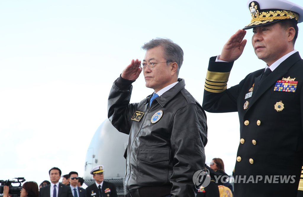 South Korean President Moon Jae-in (2nd from R) salutes while inspecting naval vessels from 13 countries at the International Fleet Review held in waters off his country's southern island of Jeju on Oct. 11, 2018. (Yonhap)