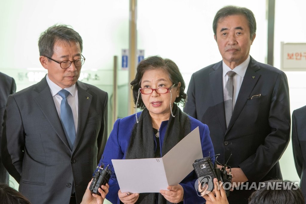 In this photo provided by the town of Goseong, Hyundai Group Chairwoman Hyun Jeong-eun (C) speaks to reporters at the customs, immigration and quarantine (CIQ) office in Goseong after returning from a two-day visit to North Korea to celebrate the 20th anniversary of the now-suspended joint tour program at the North's scenic Mount Kumgang. (Yonhap)