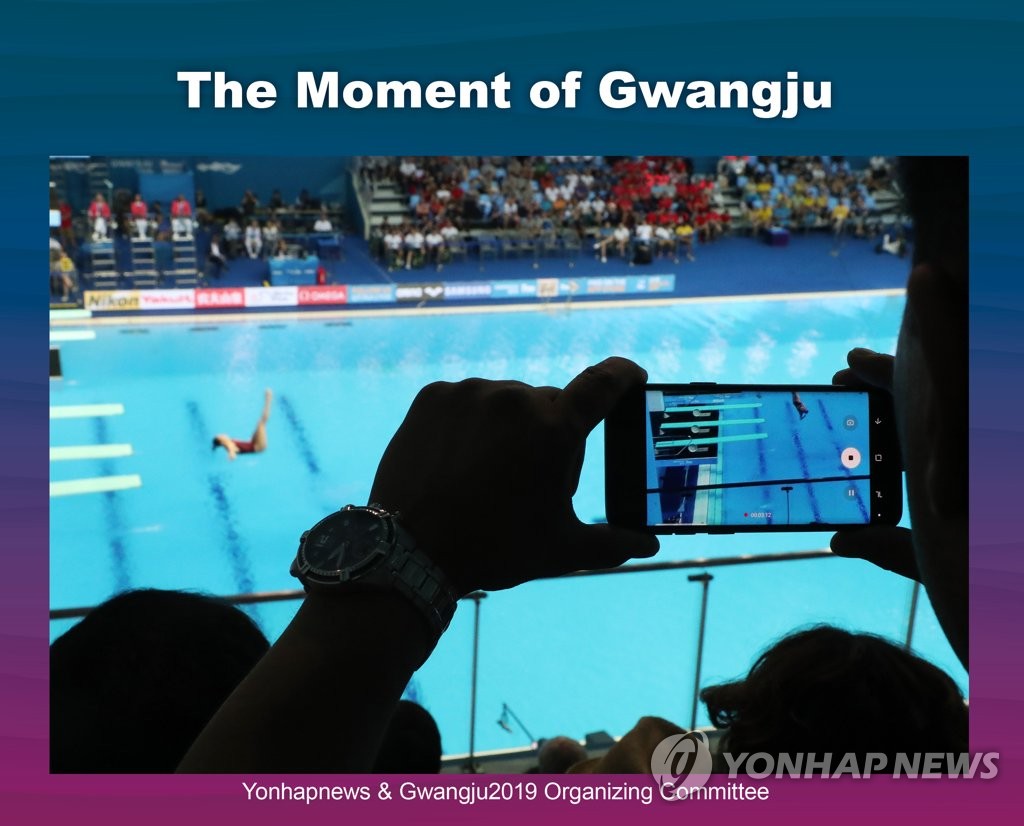 Spectator photographs diver in Gwangju Spectator photographs diver in Gwangju