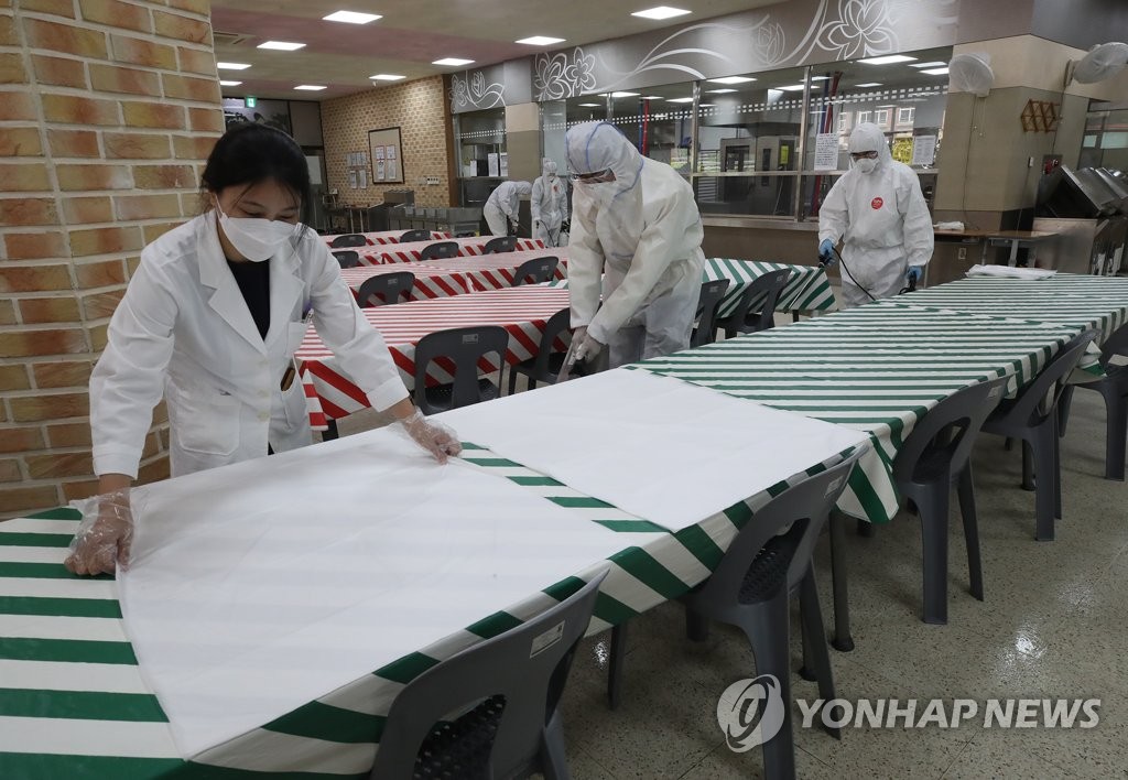 Health authorities disinfect a cafeteria at a high school in the southeastern Seoul ward of Songpa on May 11, 2020. (Yonhap)