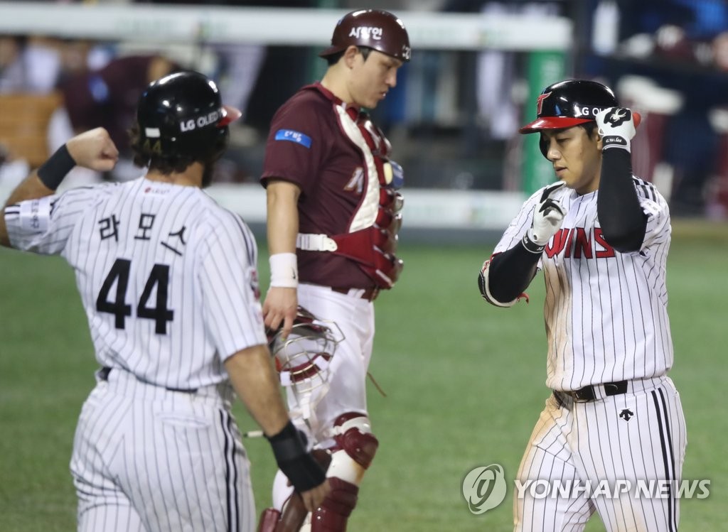 In this file photo from Sept. 10, 2020, Lee Chun-woong of the LG Twins (R) celebrates his three-run home run against the Kiwoom Heroes with teammate Robert Ramos (L) during the bottom of the seventh inning of a Korea Baseball Organization regular season game at Jamsil Baseball Stadium in Seoul. (Yonhap)