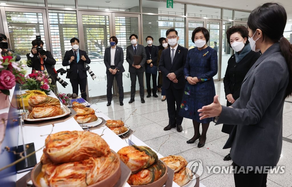First lady Kim Jung-sook (3rd from R) looks at a display of kimchi at the National Agricultural Cooperative Federation office in Seoul on Nov. 20, 2020. (Yonhap)