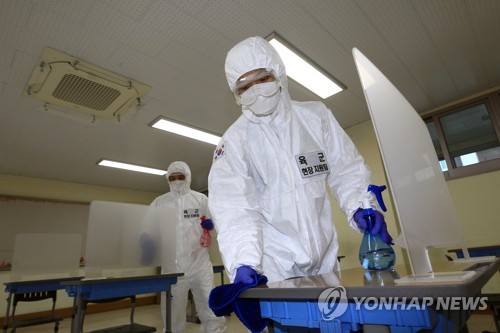 This photo, taken on Nov. 27, 2020, shows military personnel conducting disinfection work at a state college entrance examination site in Sokcho, 213 kilometers east of Seoul. (Yonhap)