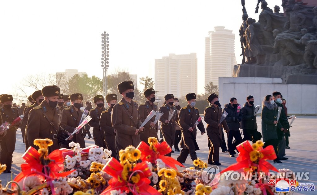 In this file photo taken Dec. 17, 2020, and released by North Korea's official Korean Central News Agency, North Koreans visit Mansudae Hill in Pyongyang to offer flowers at bronze statues of former North Korean leaders Kim Il-sung and Kim Jong-il, marking the ninth anniversary of the death of Kim Jong-il, current leader Kim Jong-un's father. (For Use Only in the Republic of Korea. No Redistribution) (Yonhap)
