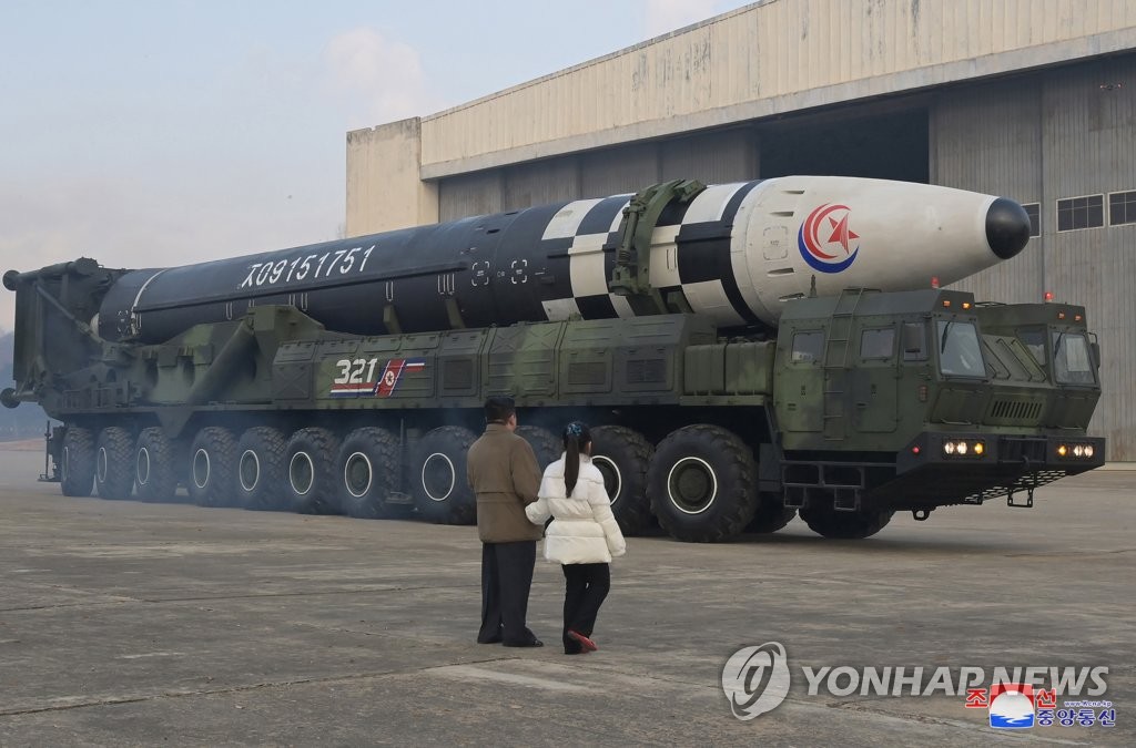North Korean leader Kim Jong-un (L), alongside his daughter wearing a winter jacket, views a new type of the Hwasong-17 intercontinental ballistic missile (ICBM) during an on-site inspection of the missile launch at Pyongyang International Airport on Nov. 18, 2022, in this photo released by the North's official Korean Central News Agency. Kim declared a resolute nuclear response to threats by the United States during the test-firing, and the missile flew 999.2 kilometers for 4,135 seconds at an apogee of 6,040.9 km before falling into the East Sea, the KCNA said. (For Use Only in the Republic of Korea. No Redistribution) (Yonhap)