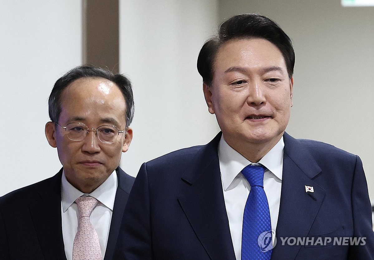 President Yoon Suk Yeol (R) enters a Cabinet meeting at the presidential office in Seoul on Nov. 28, 2023, followed by Finance Minister Choo Kyung-ho. (Yonhap)