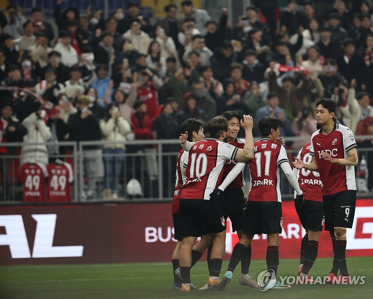 Busan IPark players celebrate after Bruno Lamas (No. 10) scored against Suwon FC during the opening leg of the K League promotion-relegation playoffs at Busan Asiad Main Stadium in the southeastern city of Busan on Dec. 6, 2023. (Yonhap)