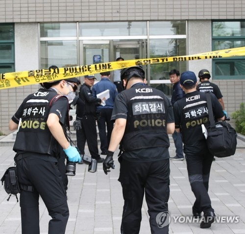 A forensic team of police officers enter the site of a parcel explosion at Yonsei University in western Seoul on June 13, 2017. (Yonhap) 