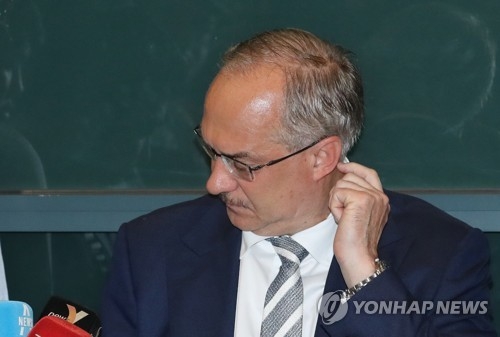 Uli Stielike, former head coach of the South Korean men's football team, listens to a reporter's question at Incheon International Airport on June 14, 2017, after arriving from a 3-2 loss to Qatar in a World Cup qualifying match in Doha. (Yonhap)