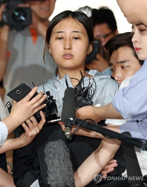 Chung Yoo-ra, the daughter of former President Park Geun-hye's longtime friend Choi Soon-sil, is surrounded by reporters at a courthouse in Seoul on June 20, 2017. She appeared at the court for a hearing to answer questions from a judge before the court decides whether to issue an arrest warrant for her, as requested by the prosecution a second time. (Yonhap) 