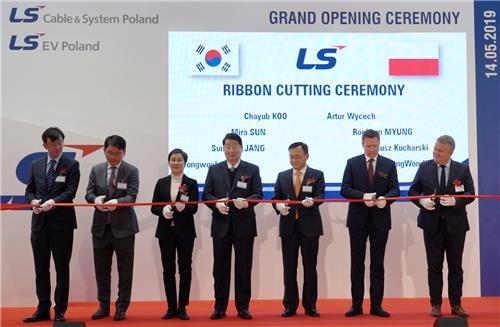 This photo provided by LS Cable & System Ltd. shows the company's executives and other officials cutting a ribbon during the opening ceremony for LS Cable's new plant in Poland on May 14, 2019. (Yonhap)