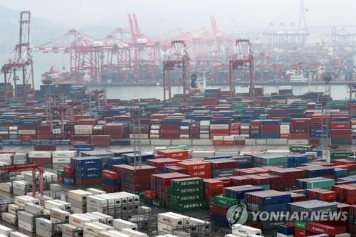 The file photo, taken Dec. 1, 2019, shows stacks of export-import containers at South Korea's largest port in Busan, located some 450 kilometers south of Seoul. (Yonhap)