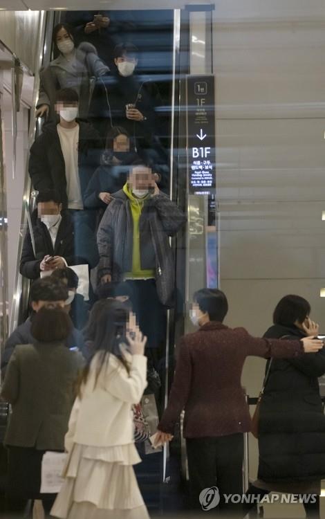 Customers leave Lotte Department Store in downtown Seoul on the afternoon of Feb. 7, 2020, as the nation's major department store decided to temporarily suspend the business due to an earlier visit by a Chinese female tourist from the coronavirus-stricken Chinese city of Wuhan before she became the 23rd confirmed patient in South Korea. (Yonhap)