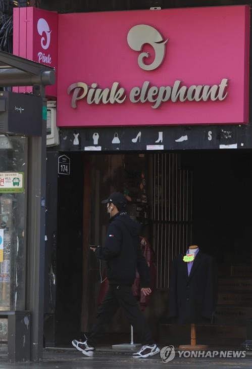 A man walks past Pink Elephant, one of clubs in the multicultural district of Itaewon in Seoul, where a new infection cluster recently originated, on May 13, 2020.