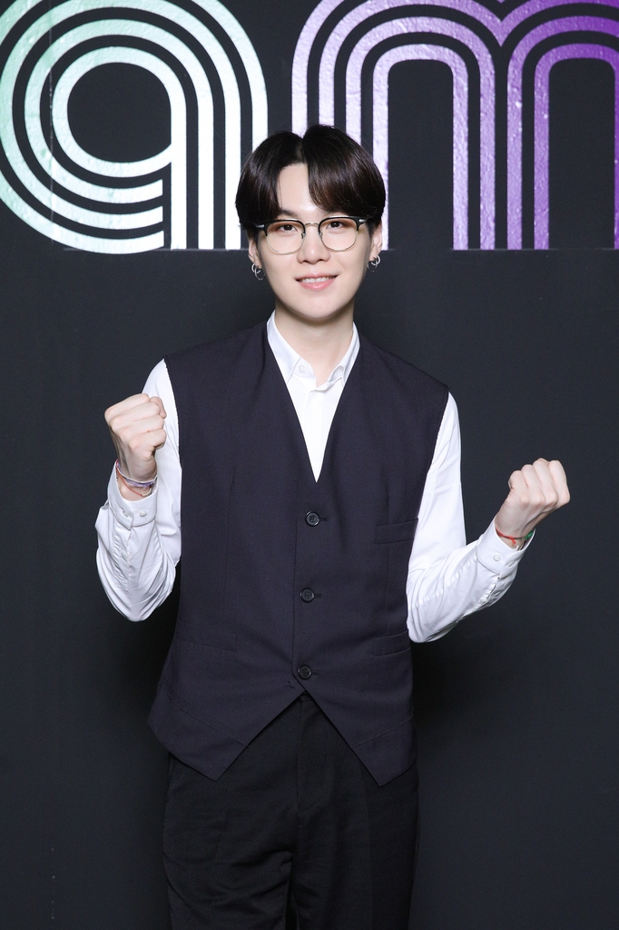 This photo, provided by Big Hit Entertainment on Sept. 2, 2020, shows member Suga of K-pop sensation BTS posing for photos during an online press conference to celebrate the band's single "Dynamite" debuting at No. 1 on the Billboard Hot 100 chart. (PHOTO NOT FOR SALE) (Yonhap)