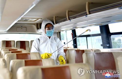 An official disinfects a bus in Pyongyang amid the coronavirus pandemic, in this undated photo released by the North's official Korean Central News Agency on Sept. 4, 2020. (For Use Only in the Republic of Korea. No Redistribution) (Yonhap)