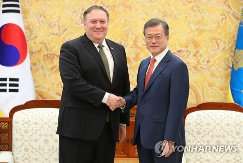 This file photo taken Oct. 7, 2018, shows South Korean President Moon Jae-in (R) shaking hands with U.S. Secretary of State Mike Pompeo at Cheong Wa Dae in Seoul. (Yonhap)