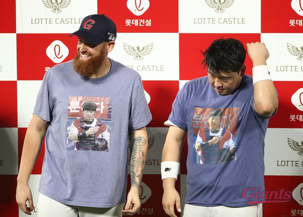 In this Aug. 12, 2020, file photo provided by the Lotte Giants, pitcher Dan Straily (L) and his catcher Kim Jun-tae sport a T-shirt produced by Straily bearing Kim's image, following a Korea Baseball Organization regular season game against the NC Dinos at Sajik Stadium in Busan, 450 kilometers southeast of Seoul. (PHOTO NOT FOR SALE) (Yonhap)
