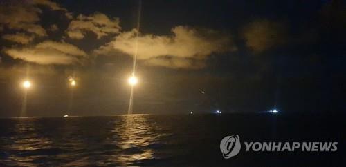 This photo provided by the Coast Guard shows rescuers search the sea off Gunsan, North Jeolla Province, on Oct. 20, 2021 after a Chinese fishing boat capsized, leaving seven crewmen missing. (PHOTO NOT FOR SALE) (Yonhap)