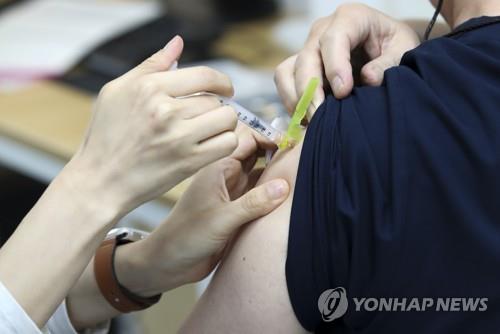 The undated file photo shows a nurse administering a coronavirus vaccine. (Yonhap)