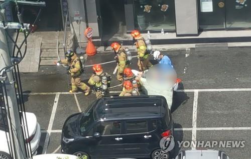 This photo provided by a news reader shows rescue workers carrying away a victim from a hospital, where a fire killed five people, on Aug. 5, 2022. (PHOTO NOT FOR SALE) (Yonhap)