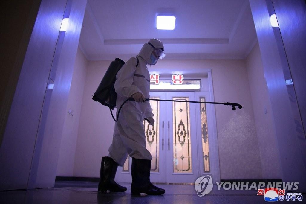 This photo, released by the North's Korean Central News Agency (KCNA) on July 1, 2022, shows an employee disinfecting Haebangsan Hotel in Pyongyang. (For Use Only in the Republic of Korea. No Redistribution) (Yonhap)