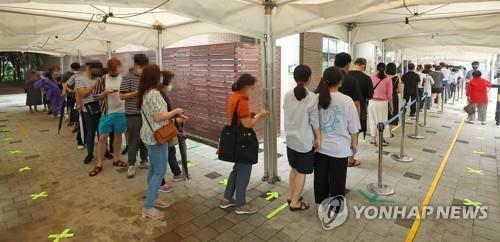 People wait to take coronavirus tests at a testing center in Seoul on Aug. 8, 2022. (Yonhap)