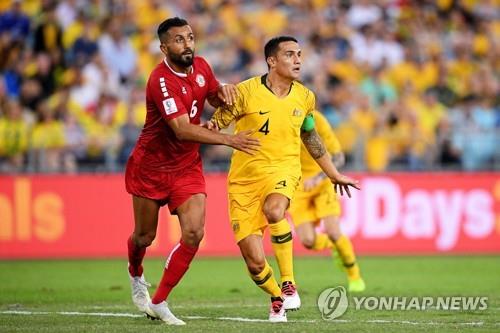 In this EPA file photo from Nov. 20, 2018, Tim Cahill of Australia (R) battles Joan Oumari of Lebanon for position during his final international match at Sydney Olympic Stadium in Sydney. (Yonhap)