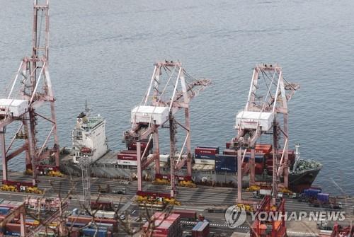 This file photo shows containers being stacked at a pier in South Korea's largest port city of Busan on Nov. 21, 2022.