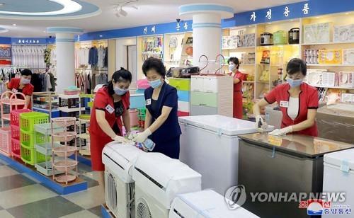 In this 2020 file photo released by North Korea's official Korean Central News Agency, store workers disinfect a shop in Pyongyang as the North steps up efforts to prevent the spread of COVID-19. (For Use Only in the Republic of Korea. No Redistribution) (Yonhap)