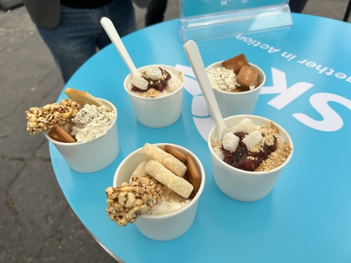 This photo shows cups of special "bingsu," a traditional Korean ice dessert, made with plant-based milk (on the bottom), and "ppeongtwigi," puffy rice crackers (on the top), served with cream cheese made with non-animal proteins. These sustainable food products are being served at a food truck run by SK outside the main exhibition hall at CES, taking place in Las Vegas from Jan. 5-8, 2023. (Yonhap) 