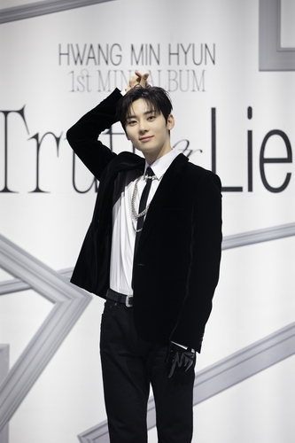 K-pop singer Hwang Min-hyun poses for the camera during a media showcase for his first solo album, "Truth or Lie," at a music hall in eastern Seoul on Feb. 27, 2023, in this photo provided by Pledis Entertainment. (PHOTO NOT FOR SALE) (Yonhap)