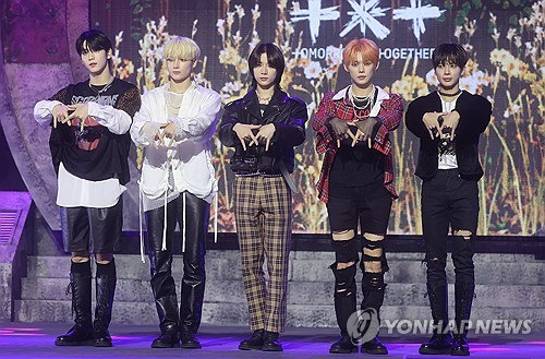 K-pop boy group Tomorrow X Together poses for photos during a media showcase held in Seoul in this file photo taken Oct. 12, 2023, for its third full-length album, "The Name Chapter: Freefall." The album came out on Oct. 13. (Yonhap)