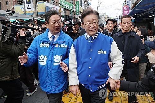 Lee Jae-myung (R), líder del principal opositor Partido Demócrata, visita un mercadillo en Seúl el 6 de marzo de 2024, en apoyo de Hwang Hee (L), candidato del PD para las elecciones generales del 10 de abril.  (Foto de la piscina) (Yonhap)