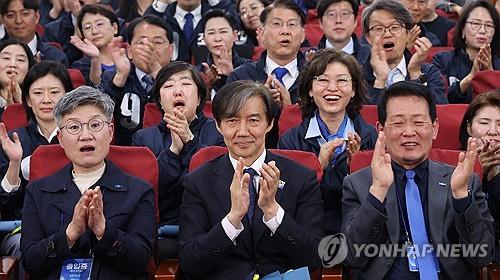 Officials of the minor Rebuilding Korea Party, including its leader Cho Kuk (C, front row), react at the National Assembly in Seoul on April 10, 2024, as TV exit polls project their performance in the general elections to choose 300 lawmakers as positive. (Yonhap)