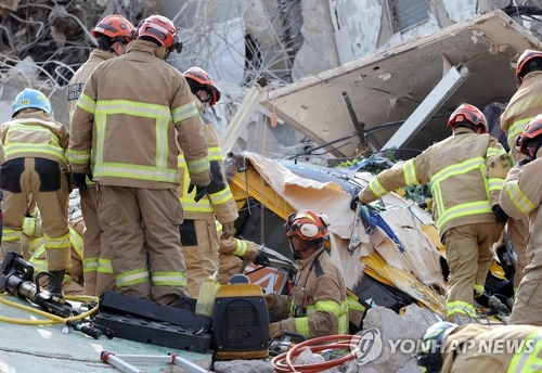 Les pompiers mènent une opération de sauvetage, le mercredi 9 juin 2021, après qu'un bâtiment s'est effondré dans un site de construction à Gwangju, dans le sud-est du pays.