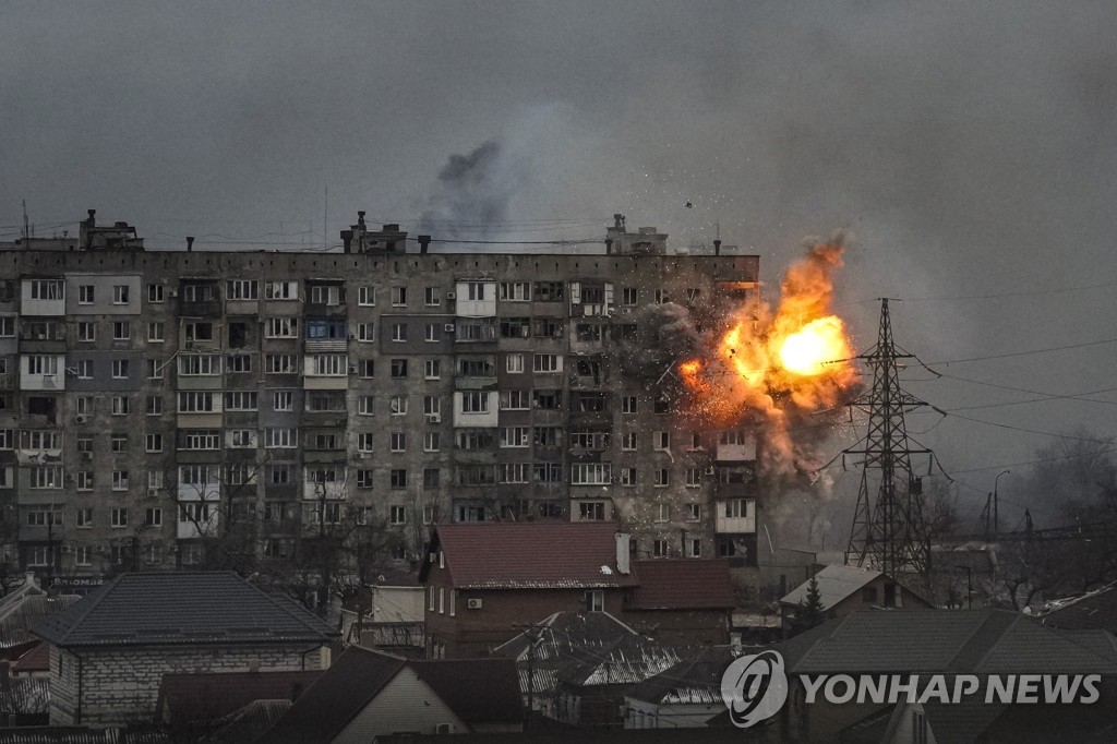 An apartment building in Mariupol, Ukraine, is attacked by a Russian tank.